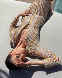 Close-up of crochet hollow wave texture on a colorful V-neck beach maxi dress