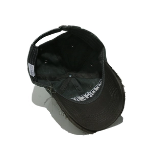 Detailed interior of distressed baseball cap showing 100% cotton fabric and sewing lines
