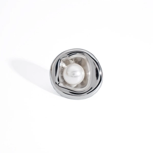 Macro shot of silver irregular oval ring with polished finish and white pearl detail