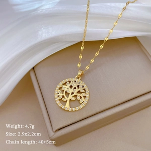 Golden Tree of Life necklace with dimensions 2.9x2.2cm and 4.7g weight displayed on silk