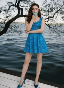 Detailed view of the ruffle neckline on a blue floral sleeveless summer dress
