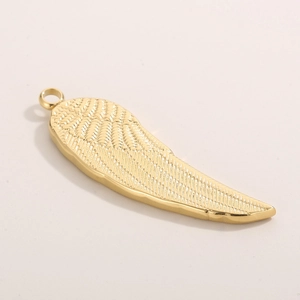 Gold stainless steel angel wing pendant featuring detailed feather texture on beige background
