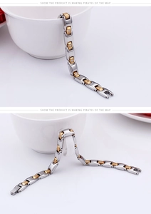 Detail of two-tone chain link bracelet with sparkling cubic zirconia inlays