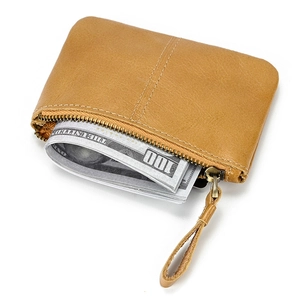 Detail view of semi-open crazy horse leather wallet filled with dollar bills in brown
