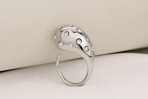 Macro shot of silver teardrop stainless steel ring with clear sparkling zirconia inlay