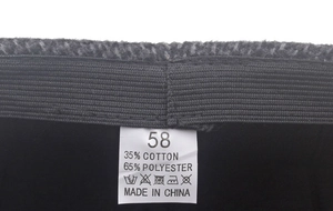 Detailed macro view of inner sweatband and fabric care label for winter flat cap