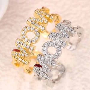 Macro shot of gold and silver MOM rings with micro-pave cubic zirconia setting