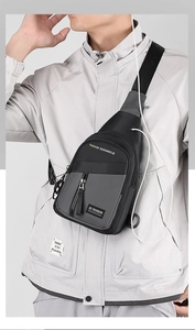 Close-up of lightweight black and grey sling bag with adjustable strap and earphone port