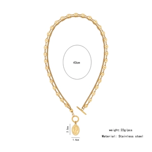 Detail of double-layer gold stainless steel chain with coin pendant and T-bar clasp