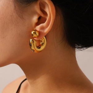 Minimalist gold C-shaped stainless steel earrings with sphere backing on model