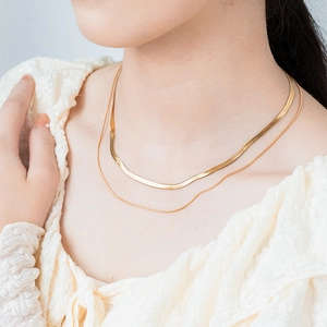 Double-layered gold stainless steel necklace featuring snake chain and twisted link styles