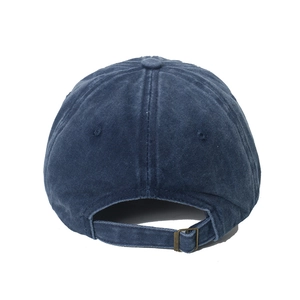 Detail view of washed denim baseball cap with adjustable metal buckle and strap