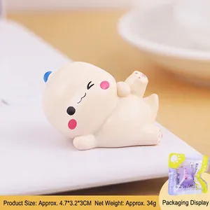 Cute mini dinosaur desktop ornament with pink blush and blue accessories, 4.7x3.2x3cm