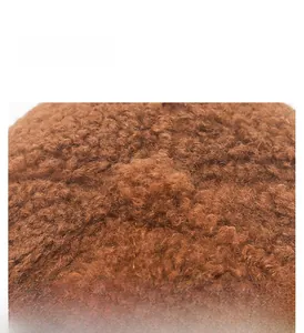 Close-up of the thick brown teddy fleece fabric texture and high-quality stitching on hat