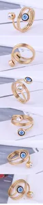 Golden spiral ring featuring a spinning blue evil eye and clear cubic zirconia stone