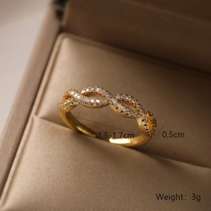 Macro shot of gold-plated twisted ring with white zircon stones and size details