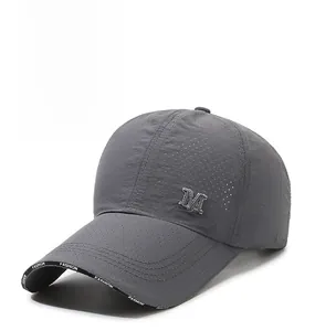 Close-up of breathable mesh fabric and metal M logo on dark gray baseball cap