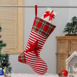 Knitted Christmas stocking with red white stripes and plaid cuff for holiday decor