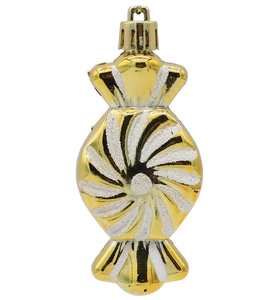 Close-up of golden candy-shaped Christmas ornament with white glitter spiral patterns