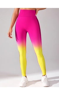 Macro shot of seamless high waist yoga leggings with pink to yellow gradient and side cutouts