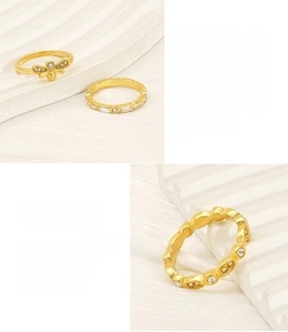 Detail of 18K gold-plated stainless steel rings featuring a bee design and white zircons
