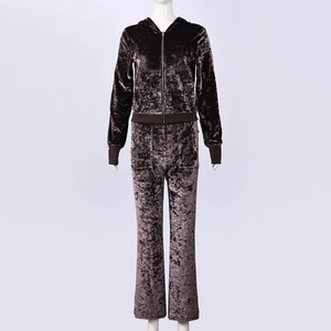 Detailed view of dark brown velvet tracksuit with embossed texture and zip hoodie