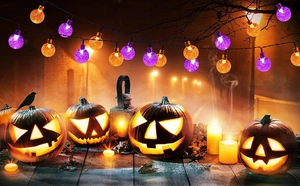 Detail of waterproof outdoor solar bubble ball string lights with purple and orange LED glow