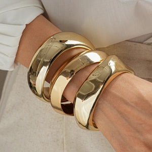 Three-piece gold chunky acrylic bangles with geometric polished organic metal design