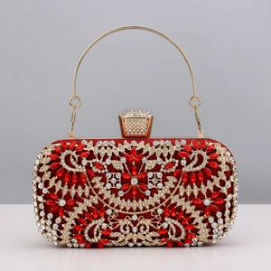 Detailed close-up of a red evening clutch with sparkling rhinestones and gold metal handle