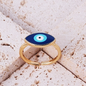 Detail of gold evil eye open ring with colorful enamel inlay on textured stone base