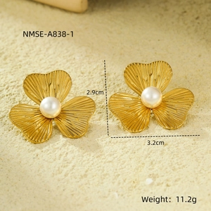 Detailed view of gold flower pearl earrings with size dimensions 2.9cm by 3.2cm
