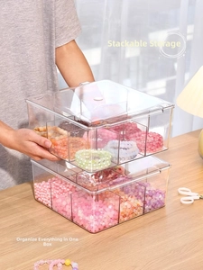 Close-up of clear acrylic multi-grid bead storage box with stacked organizers for DIY crafts