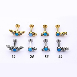 Detail of 316L steel labret studs with blue opal and zircon in gold and silver