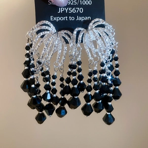 Detail of S925 silver earrings featuring elegant black crystal tiered tassels in retro style