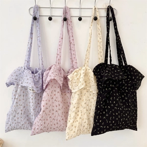 Detail showing floral tote bags in four colors with ruffled edges and soft textures