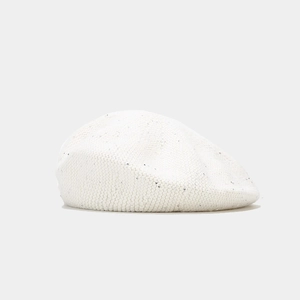Detailed view of white knitted beret featuring sparkling sequins and soft fuzzy texture