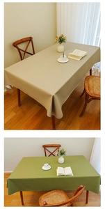 Close-up of waterproof beige and green tablecloths with a smooth leather-like texture