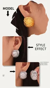 Detailed view of geometric textured earrings in gold and silver finish on a model
