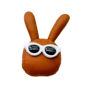 Cool brown plush bunny phone socket holder wearing white sunglasses on white background