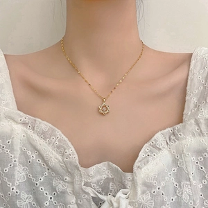 Elegant gold hexagram necklace with sparkling dancing heart stone on a model neck