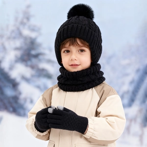 Three-piece black cable knit winter set for kids with pompom hat, scarf and gloves