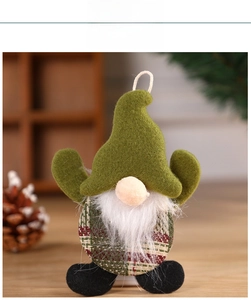 Close-up of a festive plush Christmas gnome with green hat and red plaid fabric body