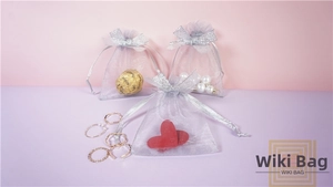 Detail of silver organza drawstring gift bags with bow for jewelry and candy storage