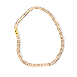 Detailed macro view of gold-plated tennis necklace featuring baguette-cut zircon stones