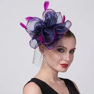 Detail of handmade purple mesh fascinator hat with magenta feathers and net veil