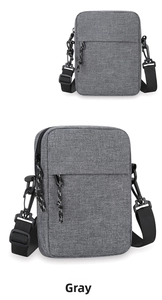 Detail view of the gray rectangular oxford crossbody bag with adjustable black strap