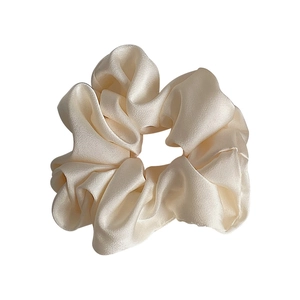 Elegant satin silk scrunchie in creamy white with premium soft textured fabric folds