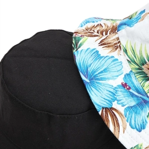 Close-up of reversible bucket hat showing black canvas and tropical floral print detail