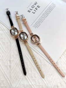 Flat lay of oval quartz watches for women in black, apricot, and soft pink colors