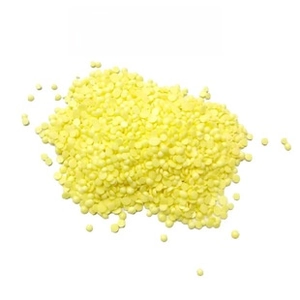 Macro shot of yellow flower-shaped toilet cleaning gel beads on a white background